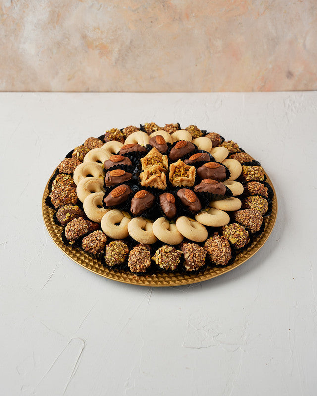 Dates, Baklawa Assorted arrangement by NJDChocolate & ConfectioneryYour Gift Contains: • 26 pieces Milk chocolate and roasted Pistachio covered majdoul dates • 18 pieces Ghuraibeh • 12pieces Milk chocolate covered Majdoul dates with Almond • 3 pieces Bakl