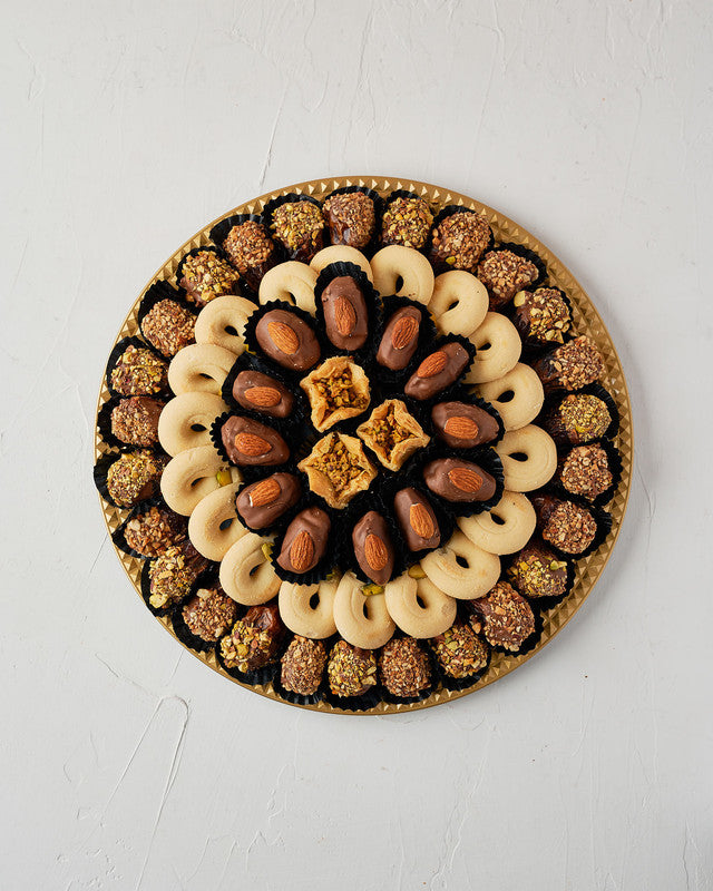 Dates, Baklawa Assorted arrangement by NJDChocolate & ConfectioneryYour Gift Contains: • 26 pieces Milk chocolate and roasted Pistachio covered majdoul dates • 18 pieces Ghuraibeh • 12pieces Milk chocolate covered Majdoul dates with Almond • 3 pieces Bakl