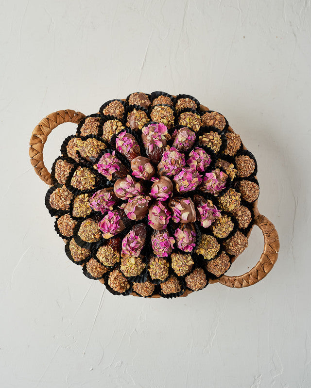 Assorted Dates Hamper by NJDChocolate & ConfectioneryYour Gift Contains: • 22 Milk chocolate covered roasted Almond Majdoul dates • 20 Milk chocolate covered rose petal Majdoul dates • 17 Milk chocolate covered roasted Pistachio Majdoul dates • Tray Size: