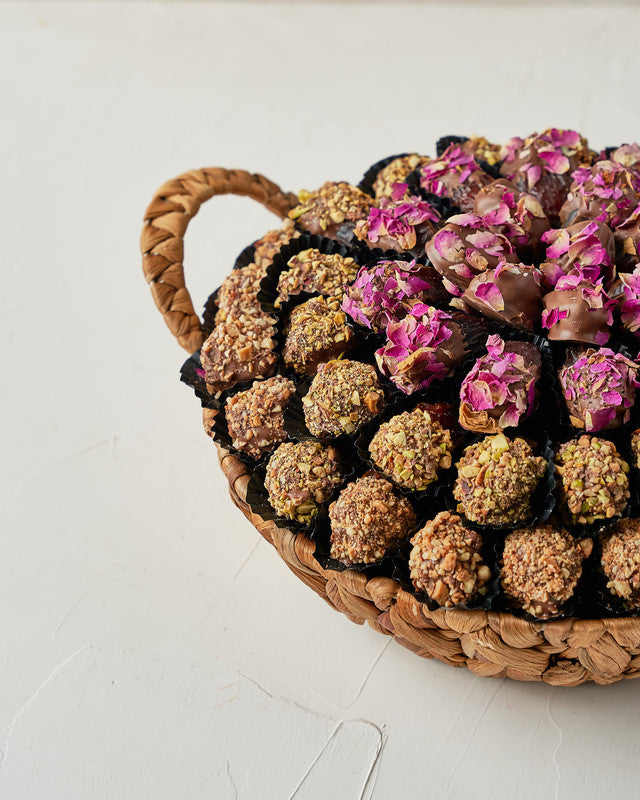 Assorted Dates Hamper by NJDChocolate & ConfectioneryYour Gift Contains: • 22 Milk chocolate covered roasted Almond Majdoul dates • 20 Milk chocolate covered rose petal Majdoul dates • 17 Milk chocolate covered roasted Pistachio Majdoul dates • Tray Size: