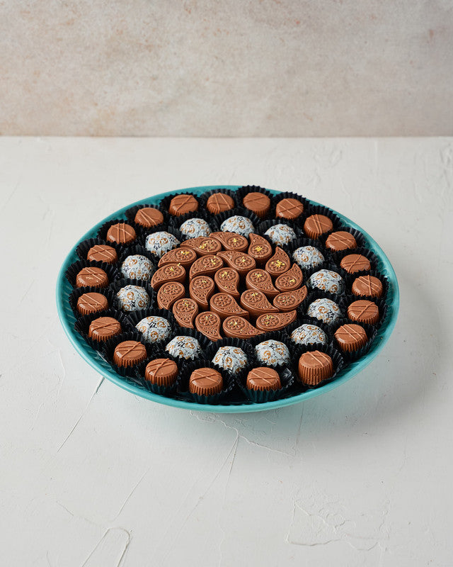 54 Chocolates Arrangement by NJDChocolate & ConfectioneryYour Gift Contains: • 54 milk chocolate in the following flavors: • Hazelnut Praline, Pistachio Praline, Sepculoos, Roasted Nuts, Ganache, Peanut Butter, Almond Praline, Rice Krispies and Black Fore