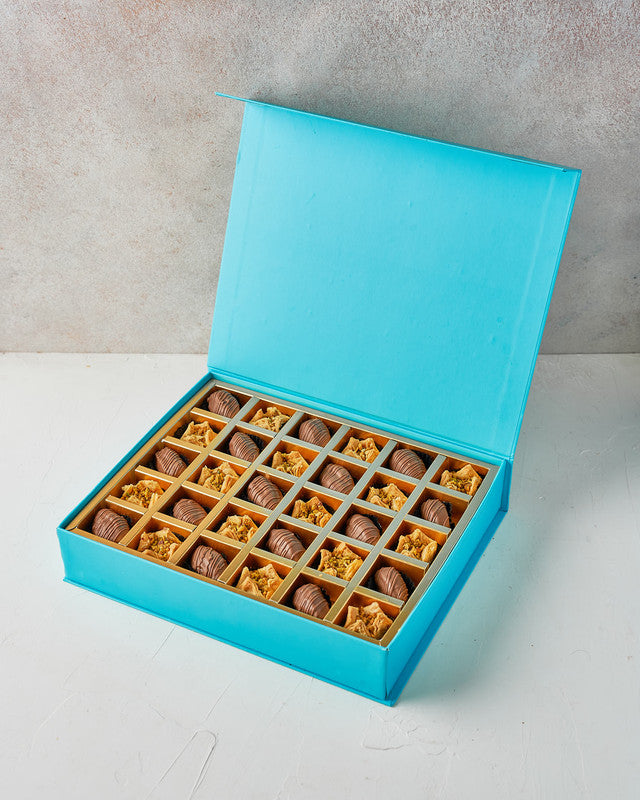 Baklawa and Dates by NJDChocolate & ConfectioneryYour Gift Contains: • 30 Milk chocolate covered Majdoul dates • 30 pieces Baklava Bookaj Pistachio • Box Size: LxBxH: 31x25.5x6cm Handling and Storage • Keep away from direct heat and sunlight • Best stored