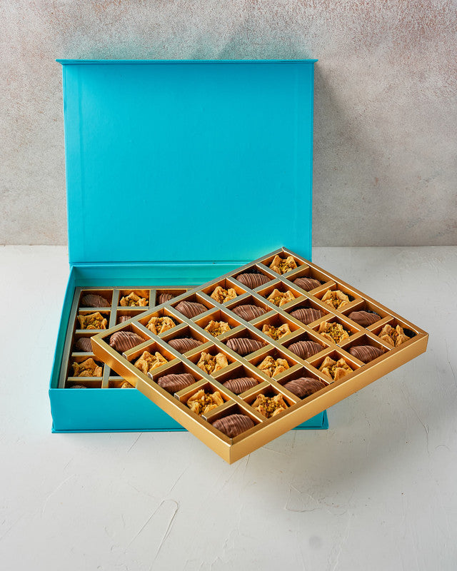 Baklawa and Dates by NJDChocolate & ConfectioneryYour Gift Contains: • 30 Milk chocolate covered Majdoul dates • 30 pieces Baklava Bookaj Pistachio • Box Size: LxBxH: 31x25.5x6cm Handling and Storage • Keep away from direct heat and sunlight • Best stored