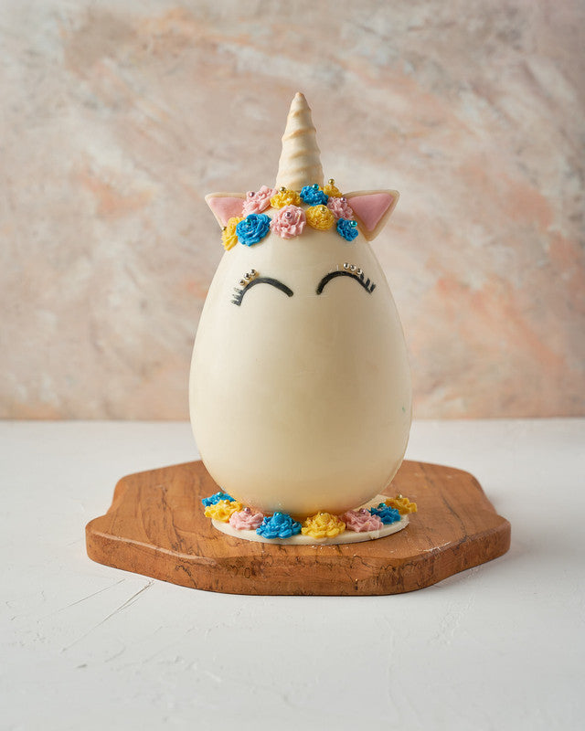 Unicorn Easter EggChocolate & ConfectioneryYour Gift Contains: • Approx. 600 grams Unicorn design white chocolate Egg • Fillings: Marshmallows, chocolates and Pretzels • Box Size: 26x26x27 cm Handling and Storage • Keep away from direct heat and sunlight