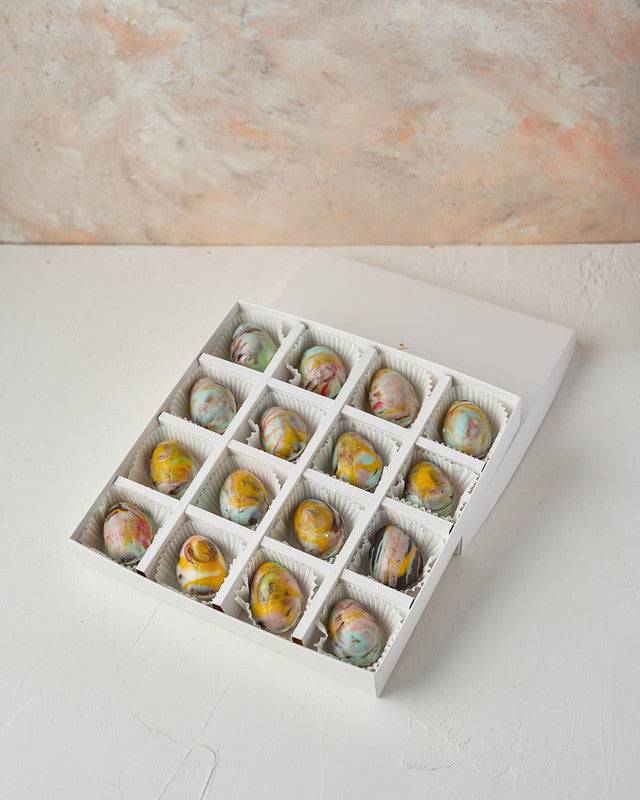 16 Marble Effect Easter EggsChocolate & ConfectioneryYour Gift Contains: • 16 pieces Belgian milk and dark chocolate marble effect Easter eggs • Weight: 400 grams approx. • Box Size: 24x24x4cm Handling and Storage • Keep away from direct heat and sunlight