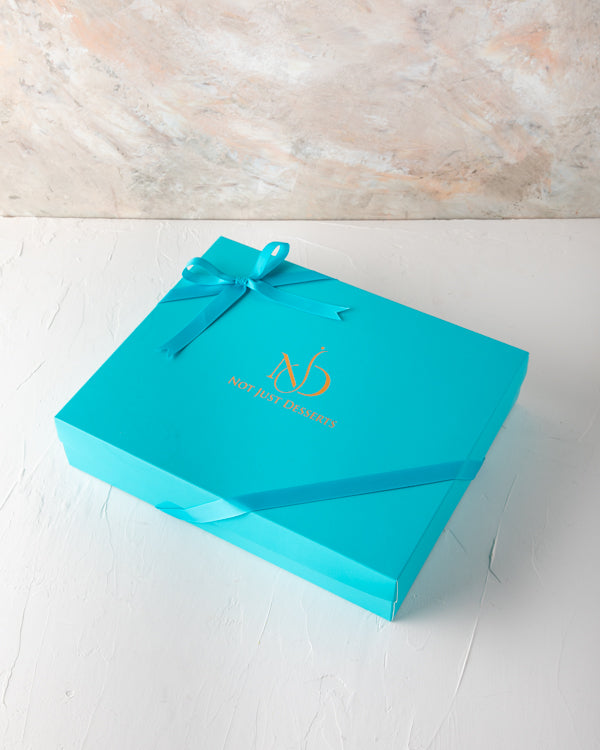 Baklawa, Dates and Chocolate Gift by NJDSweetsYour Gift Contains: Pistachio Baklawa: 6pcs Almond Baklawa: 6pcs Assorted Milk Chocolate: 12pcs Chocolate covered roasted nuts dates: 6pcs Box/Tray Size: LxBxH: 32x25x5cm HANDLING AND STORAGE Keep away from di