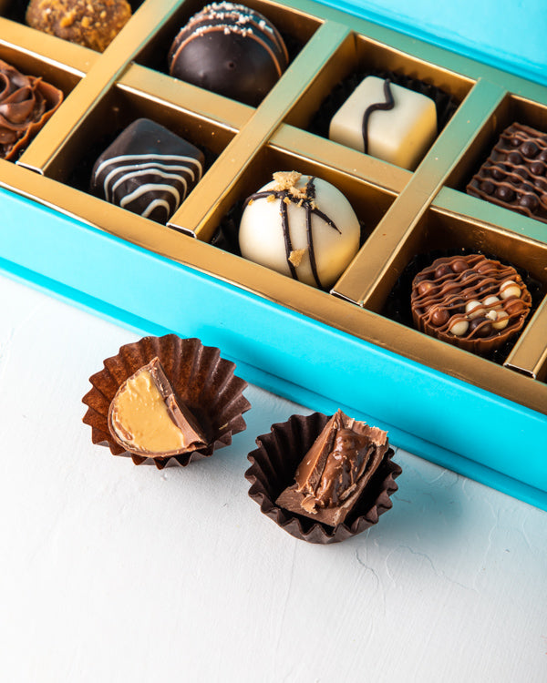 Small Assorted Box by NJDSweetsYour Gift Contains: 10 pieces assorted chocolates in Milk, Dark and White chocolate - Lotus - Hazelnut - Pistachio - Salted Caramel - Peanut Butter Box/Tray Size: LxBxH: 25x12x4cm HANDLING AND STORAGE Keep away from direct h