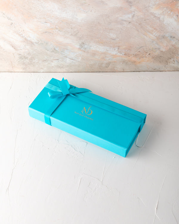 Small Assorted Box by NJDSweetsYour Gift Contains: 10 pieces assorted chocolates in Milk, Dark and White chocolate - Lotus - Hazelnut - Pistachio - Salted Caramel - Peanut Butter Box/Tray Size: LxBxH: 25x12x4cm HANDLING AND STORAGE Keep away from direct h