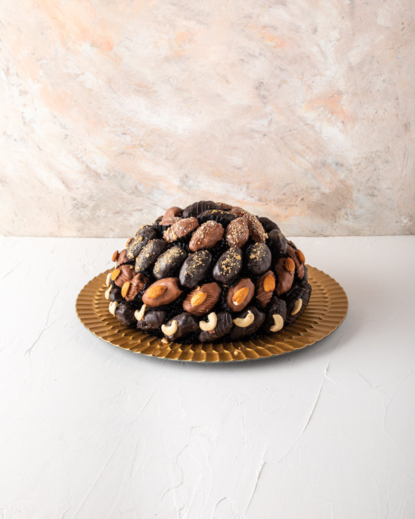 Chocolate Dates Arrangement by NJDSweetsYour Gift Contains: The arrangement contains approx. 61pcs chocolate assorted Dates with Almond, Cashew, Lotus and Edible gold toppings Box/Tray Size: LxBxH: 32x32cm HANDLING AND STORAGE Keep away from direct heat a