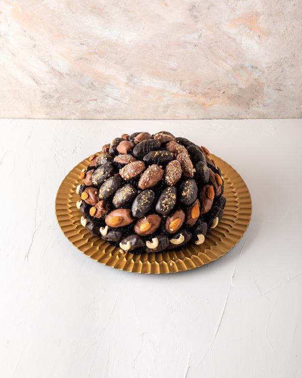 Chocolate Dates Arrangement by NJDSweetsYour Gift Contains: The arrangement contains approx. 61pcs chocolate assorted Dates with Almond, Cashew, Lotus and Edible gold toppings Box/Tray Size: LxBxH: 32x32cm HANDLING AND STORAGE Keep away from direct heat a