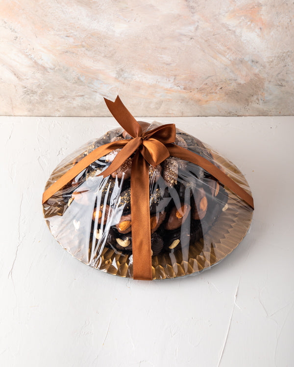 Chocolate Dates Arrangement by NJDSweetsYour Gift Contains: The arrangement contains approx. 61pcs chocolate assorted Dates with Almond, Cashew, Lotus and Edible gold toppings Box/Tray Size: LxBxH: 32x32cm HANDLING AND STORAGE Keep away from direct heat a