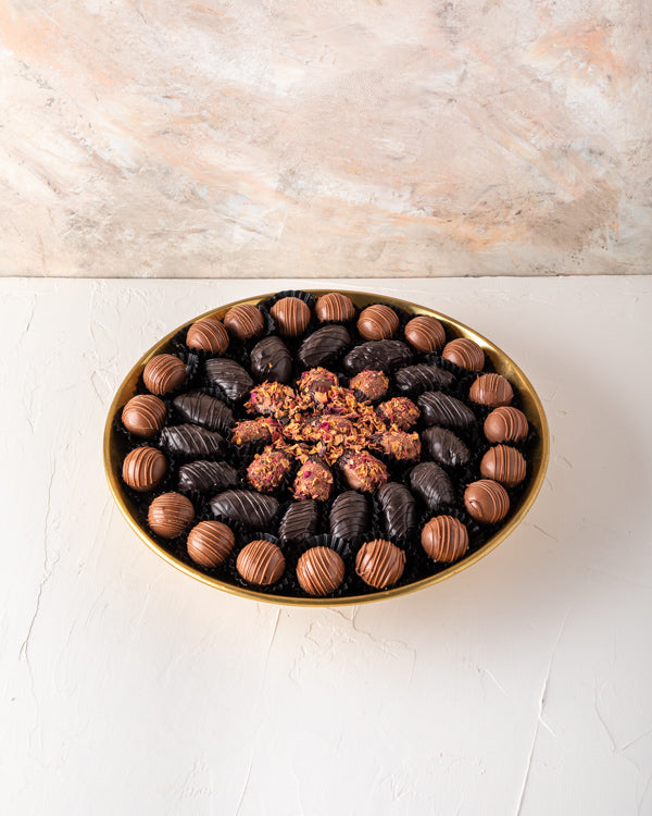 EID Gift, Truffles and Dates Arrangement by NJDSweetsYour Gift Contains: Gold metal luxurious tray decorated with truffles and dates Belgian Milk chocolate truffles: 20 pieces Dark chocolate dates: 15 pieces Rose Date: 11 pieces Box/Tray Size: LxBxH: 30x5