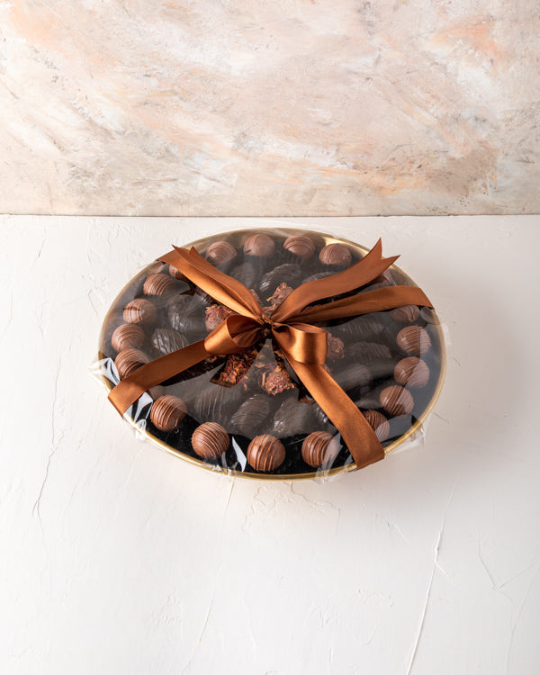 EID Gift, Truffles and Dates Arrangement by NJDSweetsYour Gift Contains: Gold metal luxurious tray decorated with truffles and dates Belgian Milk chocolate truffles: 20 pieces Dark chocolate dates: 15 pieces Rose Date: 11 pieces Box/Tray Size: LxBxH: 30x5