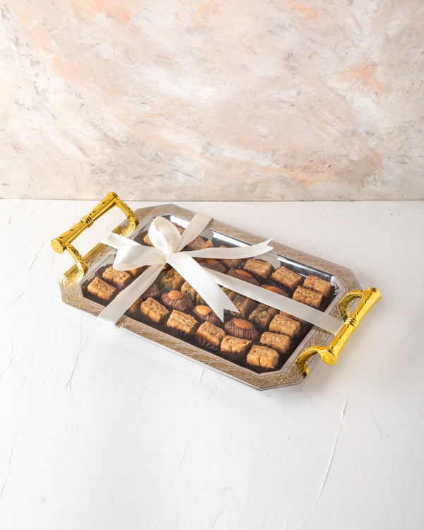 Baklawa and Tray Arrangement by NJDSweetsYour Gift Contains: Milk Chocolate Dates with Almond: 8 pieces Almond Baklawa: 21 pieces Pistachio Baklawa: 7 pieces Box/Tray Size: LxBxH: 35.5x25.6cm HANDLING AND STORAGE Keep away from direct heat and sunlight Ke