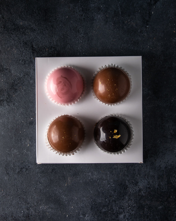 Hot Chocolate Bombs by NJDChocolate & ConfectioneryYour Gift Contains: A set of 4 hot chocolate bombs: Milk chocolate bomb: 2pcs Rose chocolate bomb: 1pcs Dark chocolate bomb: 1pcs Pour it in a cup of lukewarm/hot milk and enjoy Box/Tray Size: LxBxH: 18x1