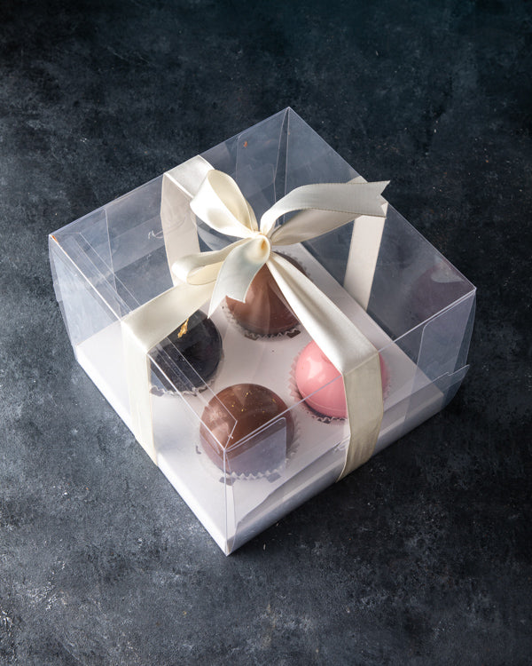Hot Chocolate Bombs by NJDChocolate & ConfectioneryYour Gift Contains: A set of 4 hot chocolate bombs: Milk chocolate bomb: 2pcs Rose chocolate bomb: 1pcs Dark chocolate bomb: 1pcs Pour it in a cup of lukewarm/hot milk and enjoy Box/Tray Size: LxBxH: 18x1