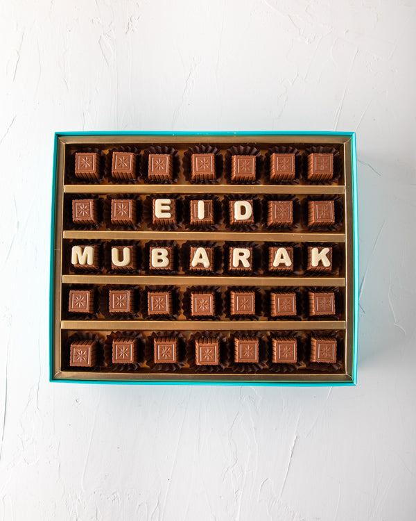 Eid Mubarak Customizable Box by NJDSweetsYOUR GIFT CONTAINS 35pieces of pure milk chocolate made with rich Belgian chocolate. Customize your EID greetings and make them feel special. Box/Tray Size: LxBxH: 31x 25.5x6cm HANDLING AND STORAGE Keep away from d