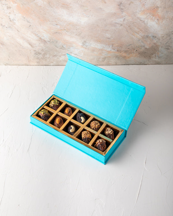 Assorted Dates 10pcs by NJDNuts Dates & Dried FruitsYour Gift Contains: 10pcs Chocolate dates covered with: - Pistachio flavors: 2pcs - Cashew flavors: 2pcs - Almond flavors: 2pcs - Coconut flavors: 2pcs - Roasted Nuts flavors: 2pcs Box/Tray Size: LxBxH: